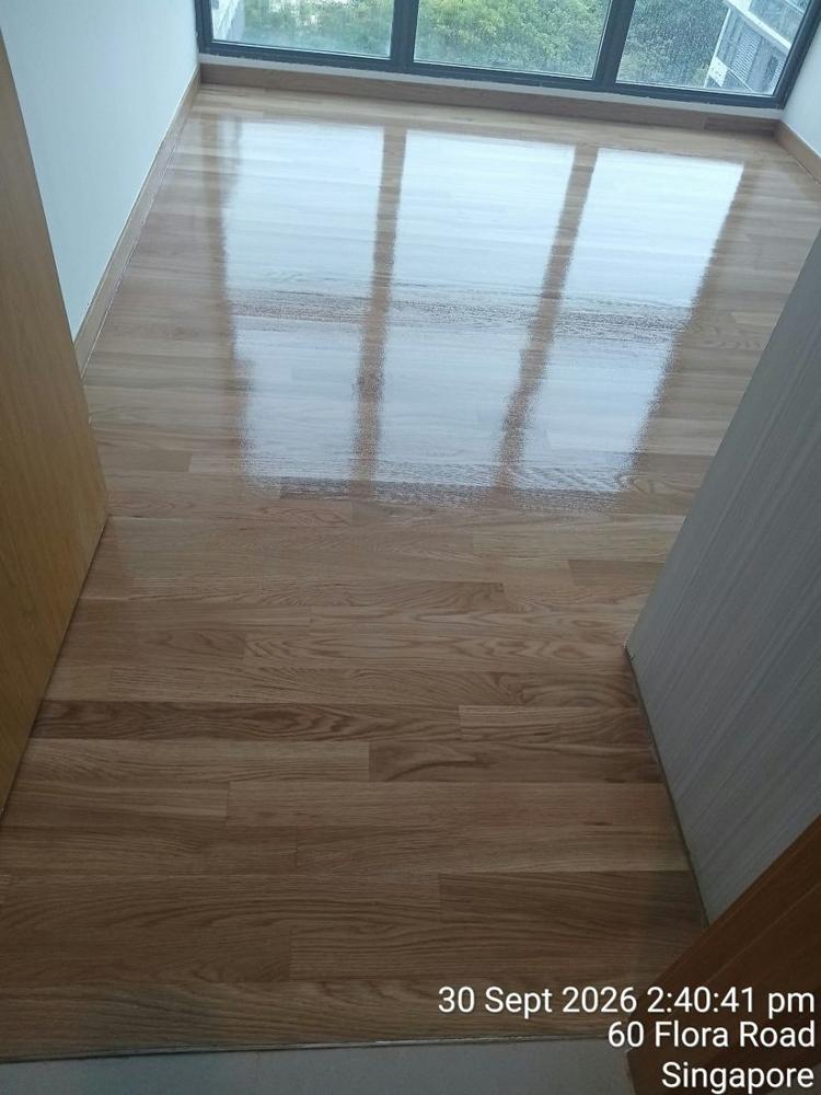 Light oak strip floor in a condo bedroom after gloss varnish
