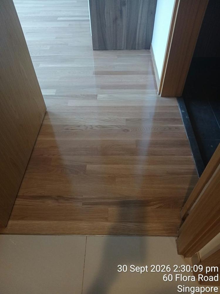 Varnished oak strip floor at a condo bedroom doorway