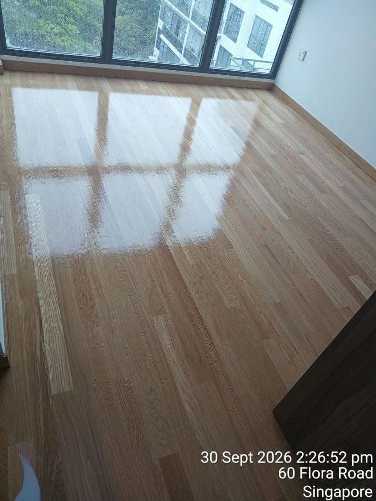 Glossy oak strip floor reflecting floor-to-ceiling windows