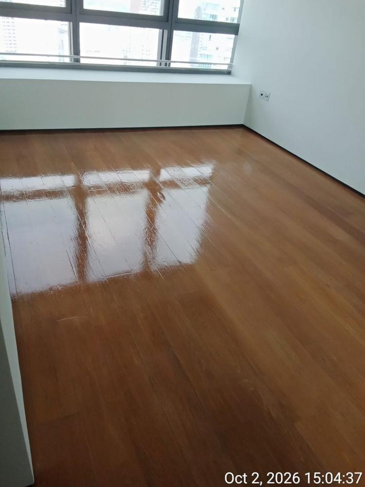 Glossy strip parquet in a condo bedroom after varnishing