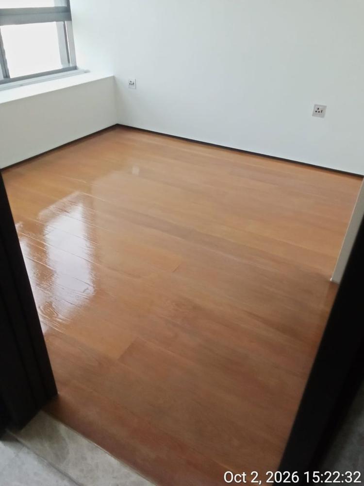 Condo bedroom with freshly varnished strip parquet