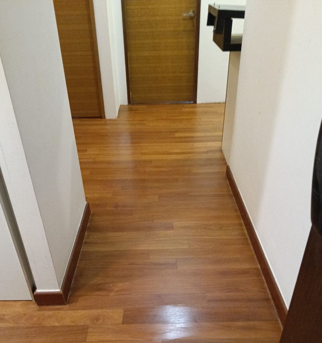 Teak strip floor in a condo corridor after refinishing