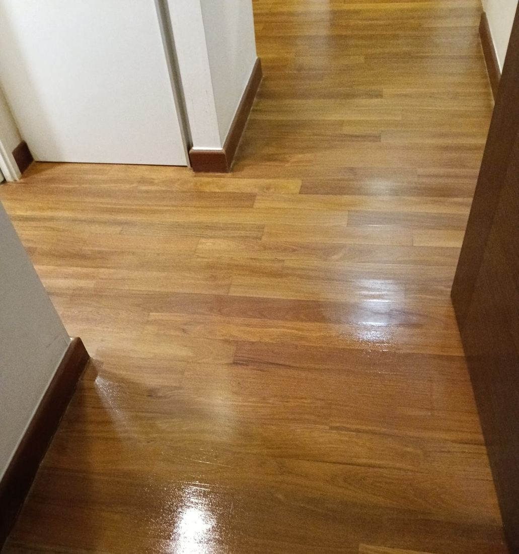Refinished teak strip floor in a condo living area