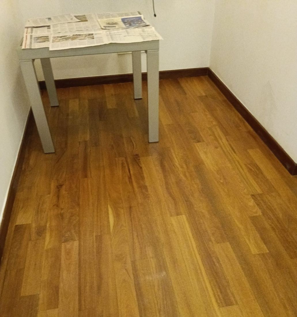 Teak strip floor in a condo room after refinishing