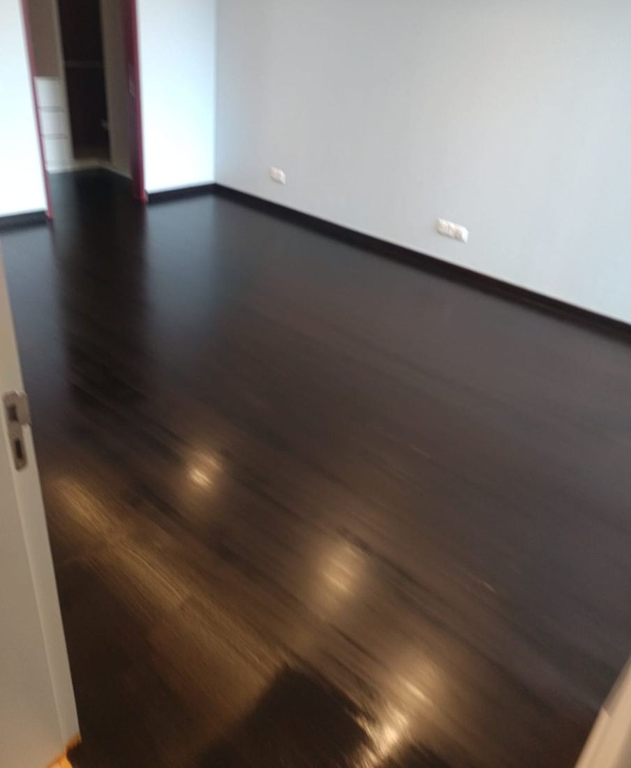 Strip parquet stained dark ebony and varnished