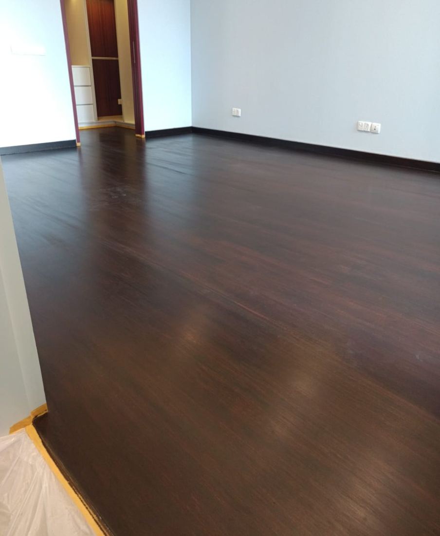 Bedroom with dark ebony-stained parquet