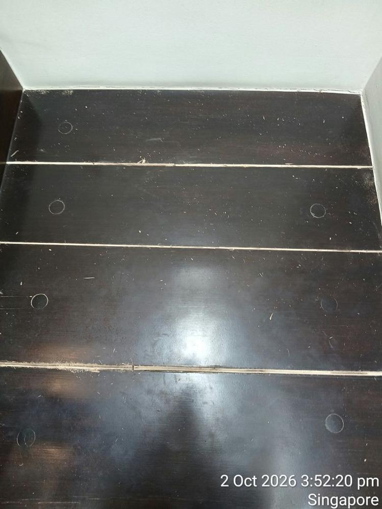 Dark-stained timber landing with gaps opened between boards