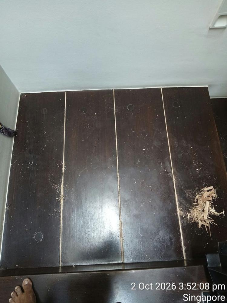Dark timber boards with gaps and splinters before repair