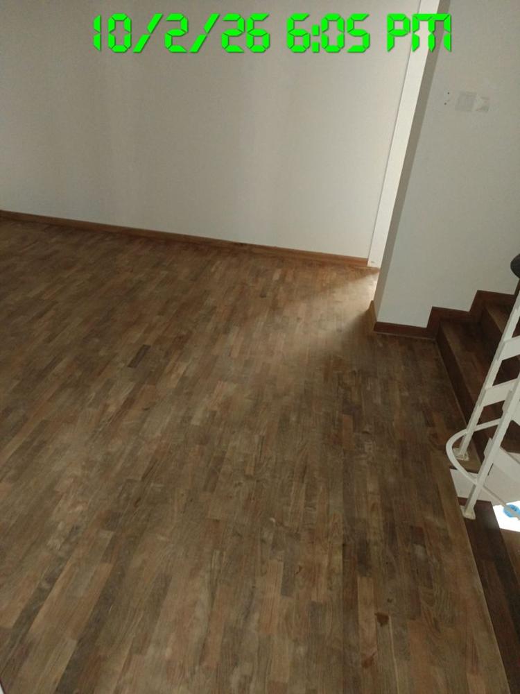Finished parquet on an upper landing next to the stairs