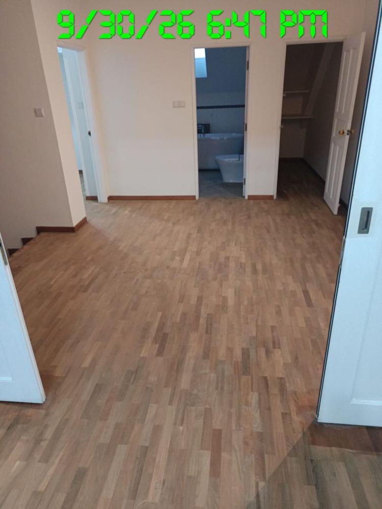 Sanded finger parquet room leading to an ensuite