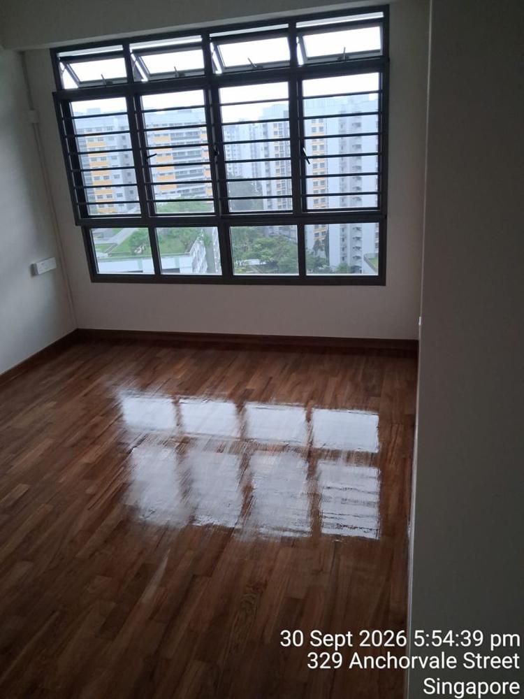 Varnished parquet reflecting the bedroom window in an HDB flat