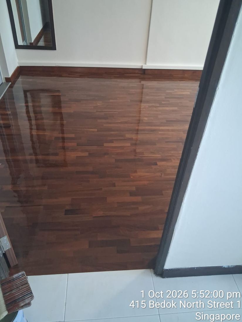 Corner of a varnished parquet room in an HDB flat