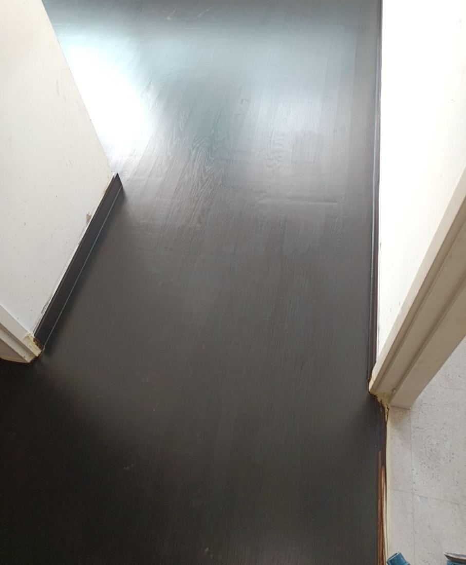 Dark satin parquet in a narrow room