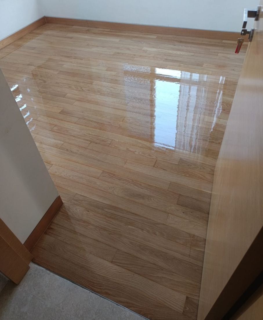 Light oak strip parquet after sanding and clear gloss varnish