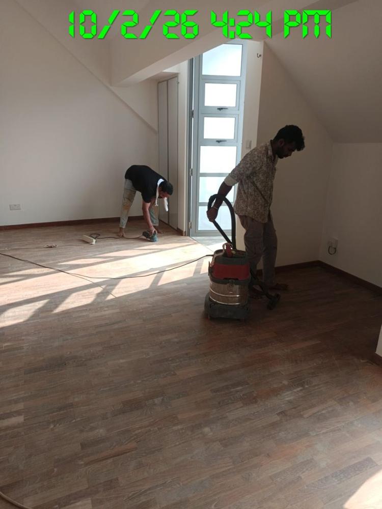 Technicians sanding finger parquet with a drum sander