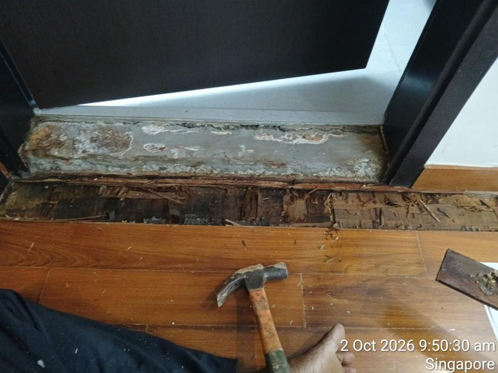Rotten timber being removed at a door threshold