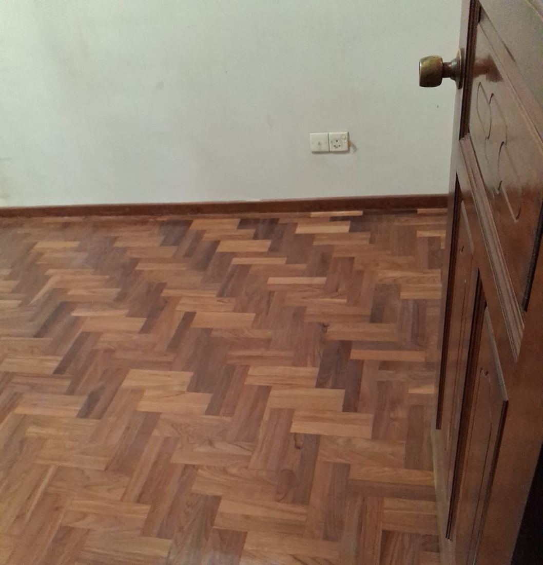 Teak herringbone parquet by a bedroom door