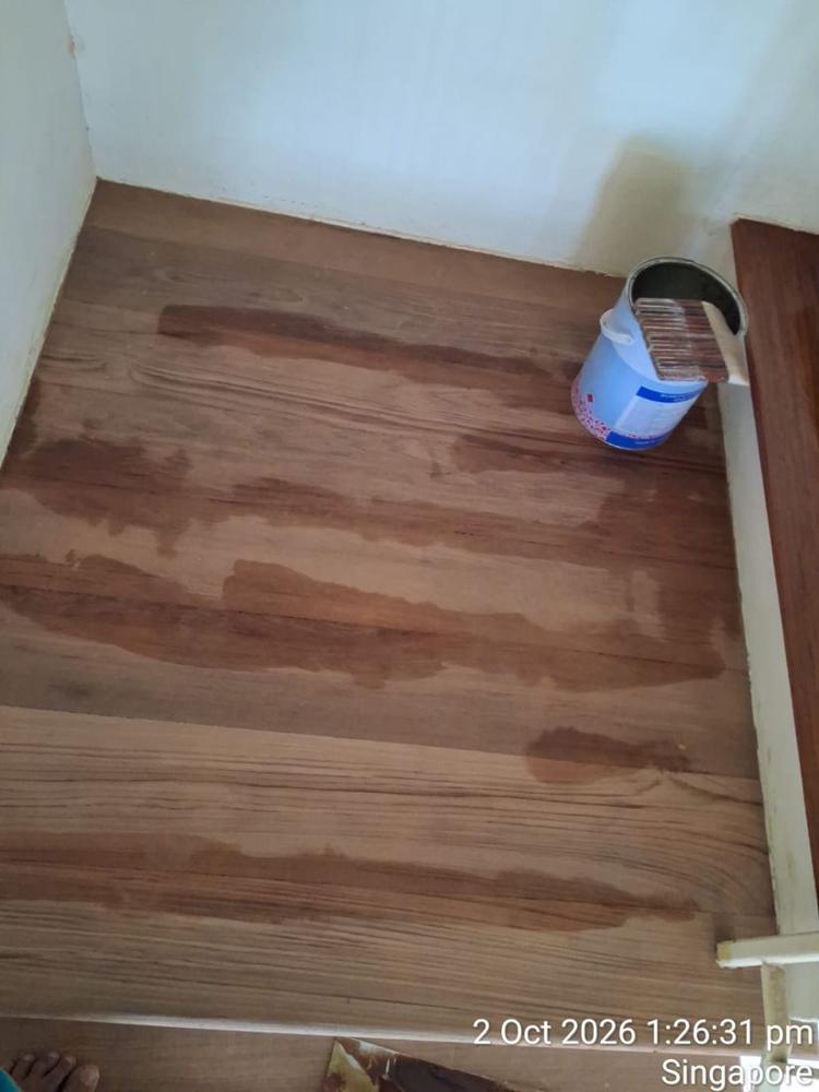 Timber stair landing with stain being applied