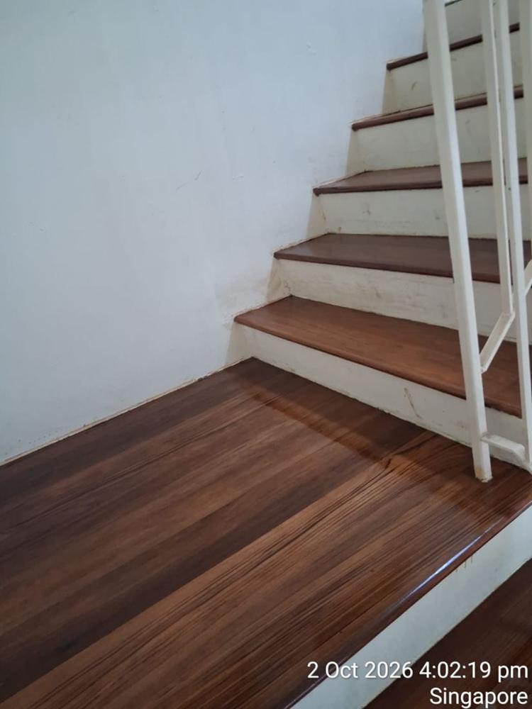 Varnished timber landing at the bottom of a staircase
