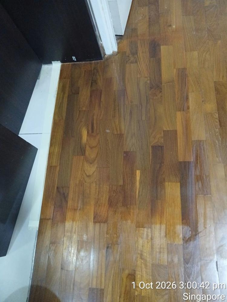 Varnished teak strip parquet beside kitchen cabinets in a Toa Payoh flat