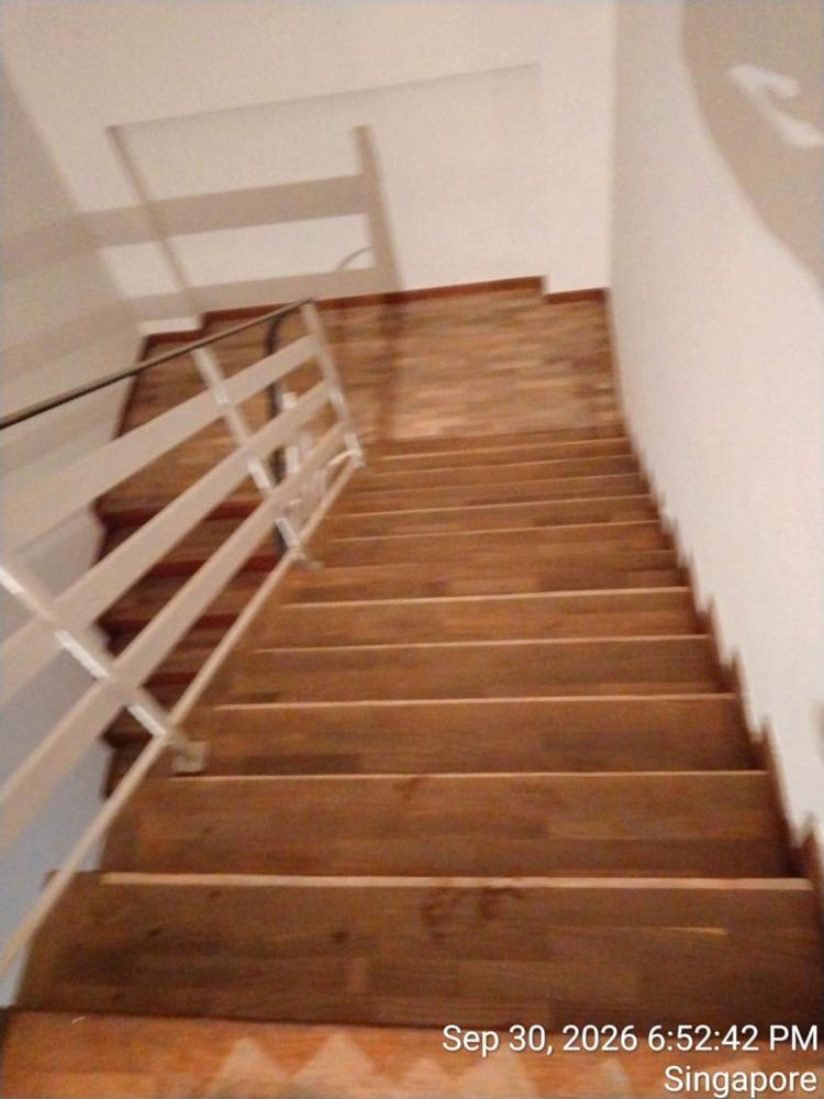 Teak stair treads with worn varnish before restoration